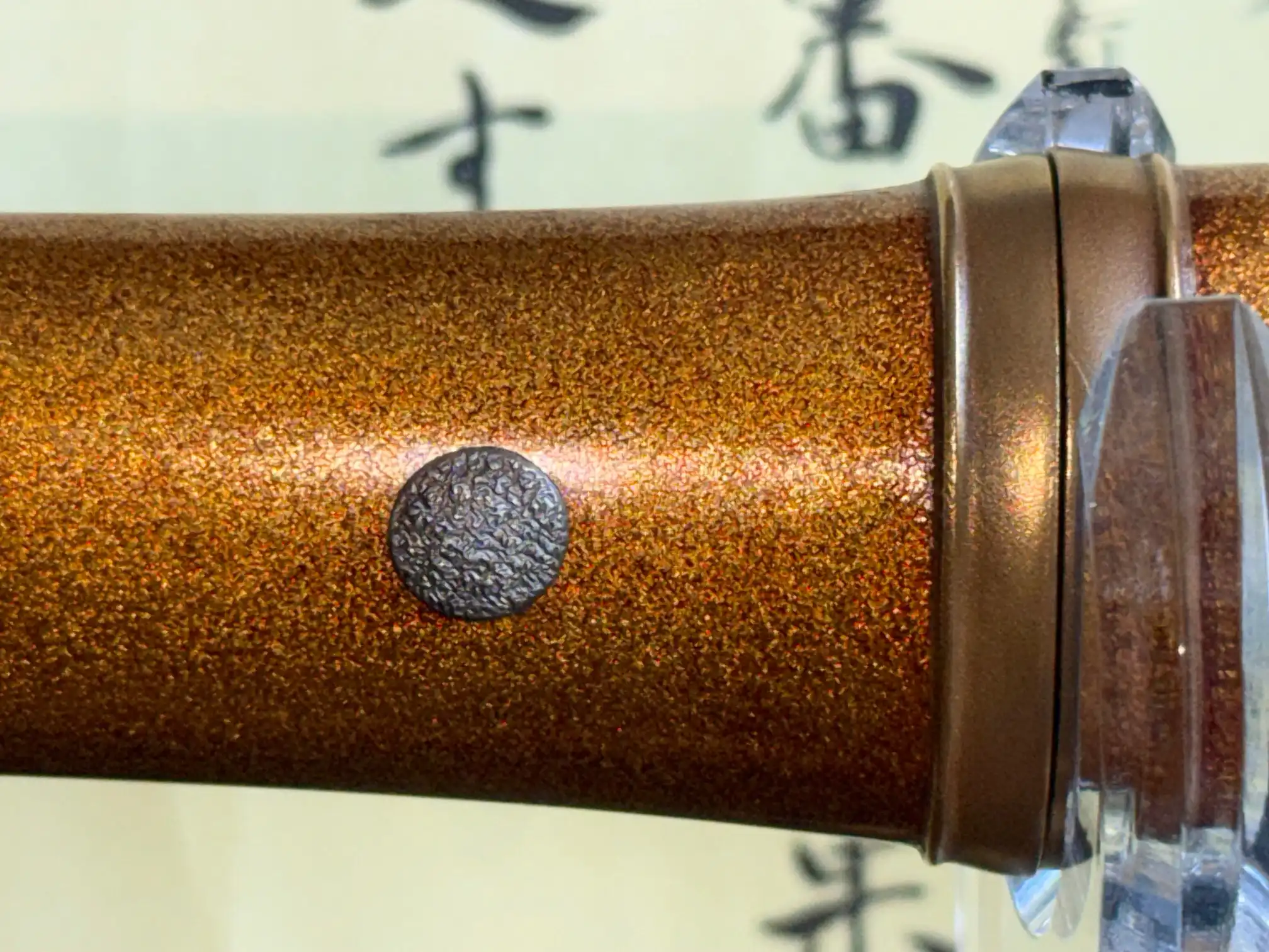Close-up of the NBTHK Jūyō Tōken Tantō by Heianjō Nagayoshi, showing the textured golden saya with a menuki