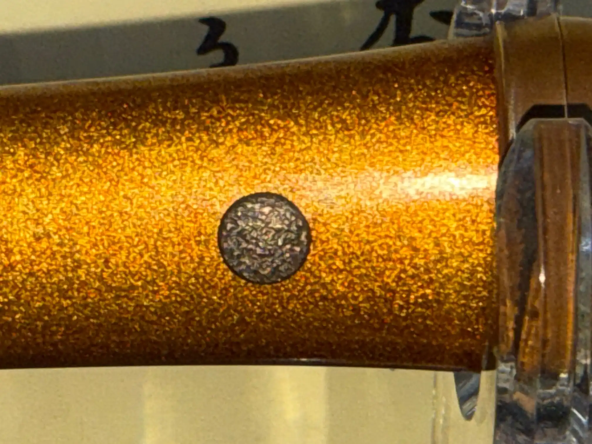 Close-up of the NBTHK Jūyō Tōken Tantō by Heianjō Nagayoshi, showing the detailed gold flecked saya with a mekugi-ana.
