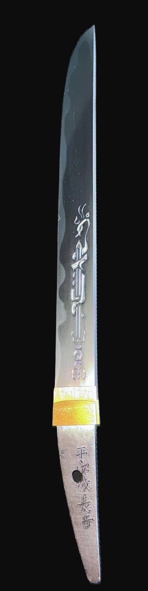 Up-close full view of a NBTHK Jūyō Tōken Tantō by Heianjō Nagayoshi with ornate engravings and gold habaki
