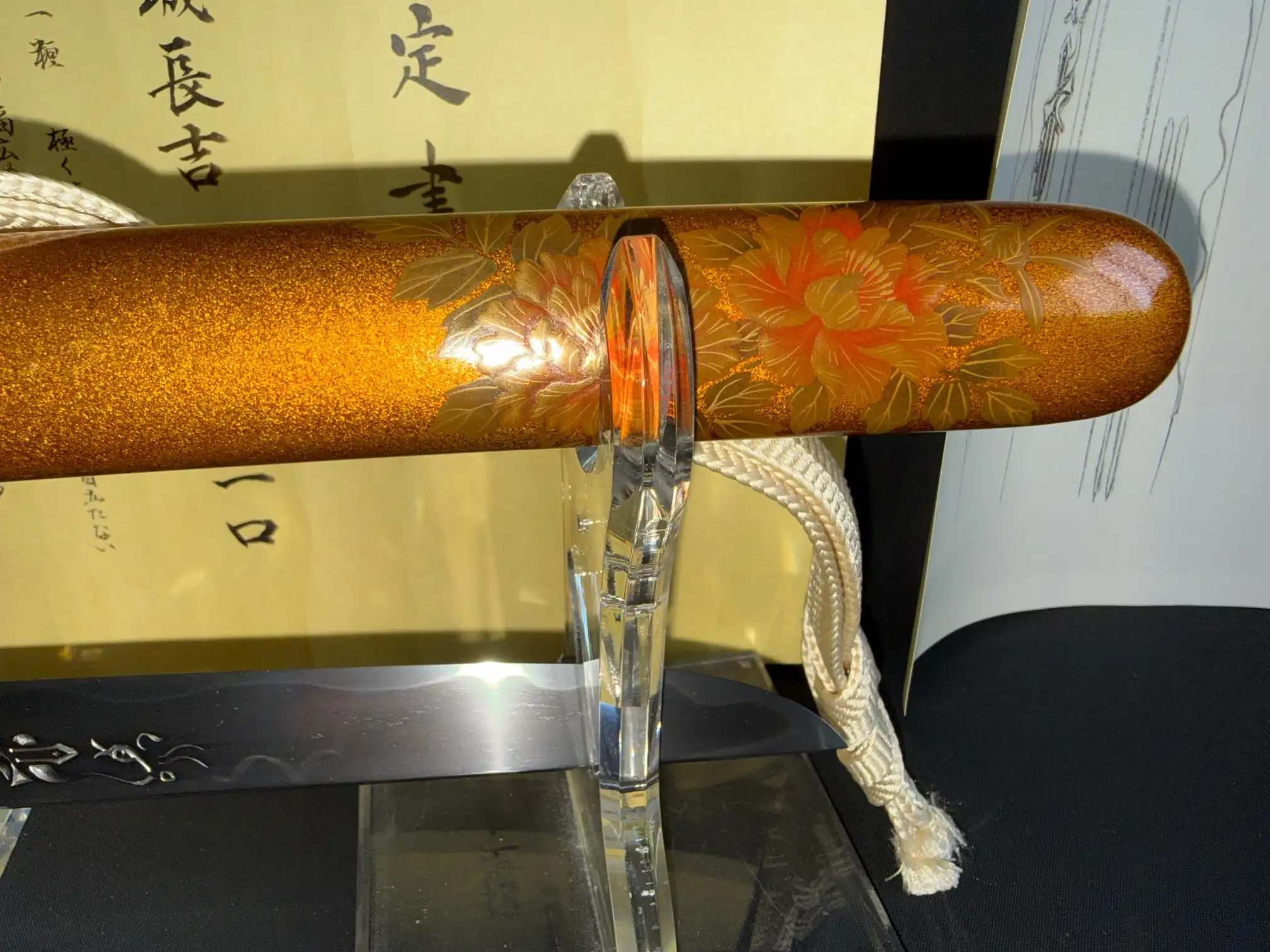 Close-up of a NBTHK Jūyō Tōken Tantō by Heianjō Nagayoshi, showing the gilded scabbard with floral motifs