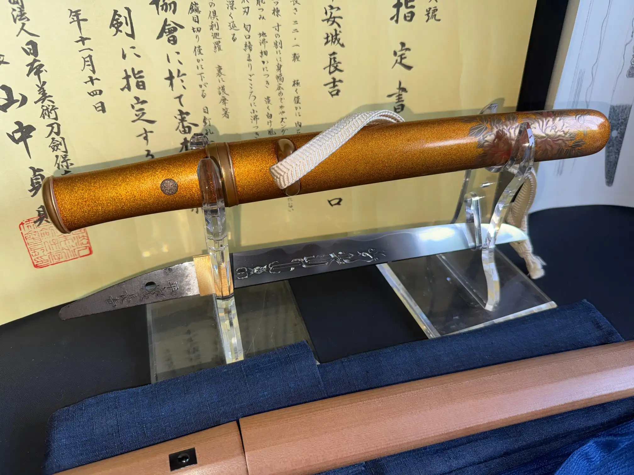 NBTHK Jūyō Tōken Tantō by Heianjō Nagayoshi, unmounted blade and ornate hilt on display with documents