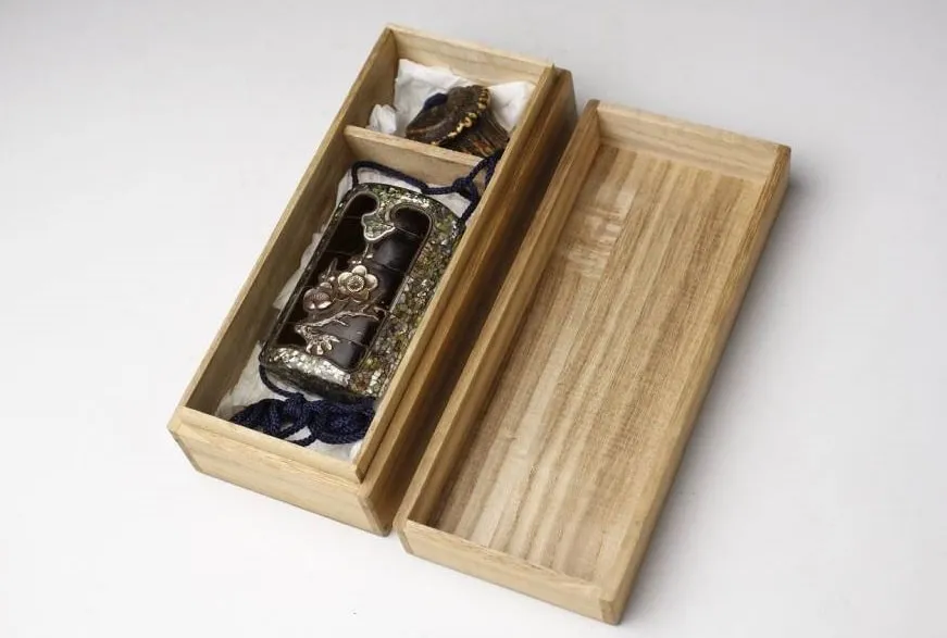 Edo Japanese Inro accessory in original wooden box with lid removed, showing intricate floral design in black and gold.