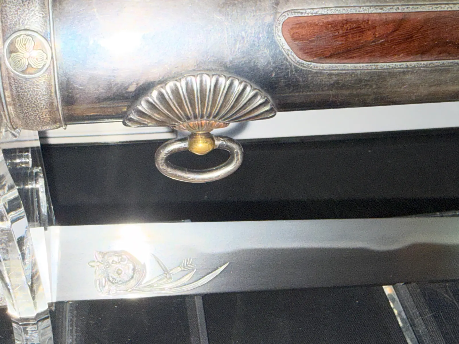 Close-up of Silver Skull Tantō by Ryūjin Minamoto Sadakazu, showing silver saya and engraved skull on blade