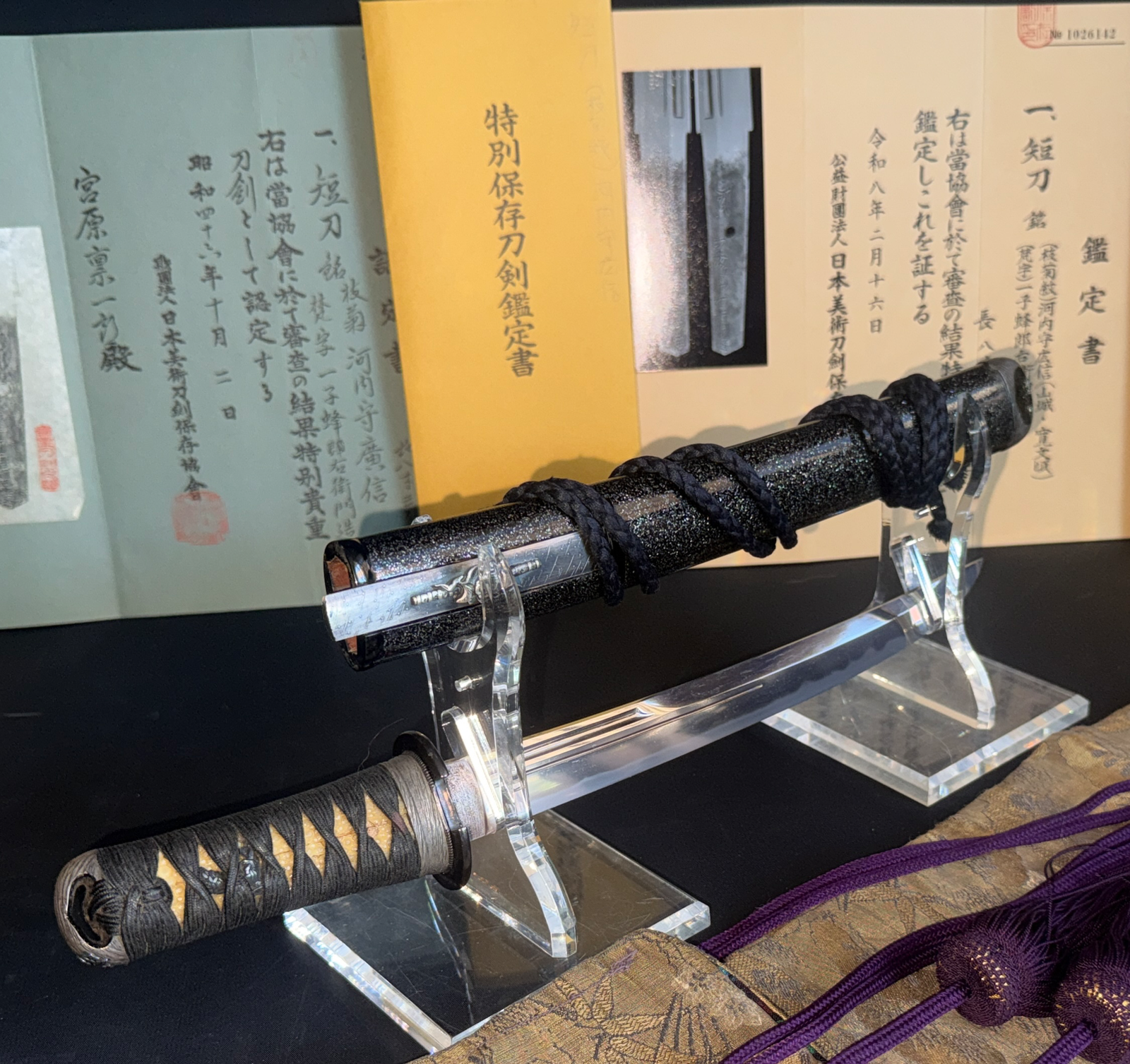 Kawachi no Kami Hironobu Tanto, a Japanese short sword, displayed with scabbard and certificates