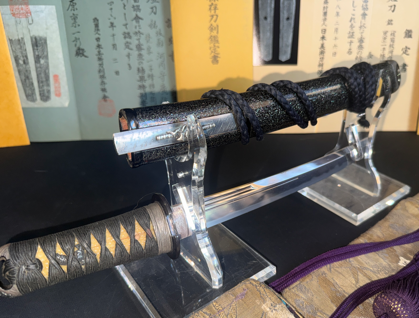 Close-up of a Kawachi no Kami Hironobu Tanto, showcasing its detailed Imperial Kikumon on display.