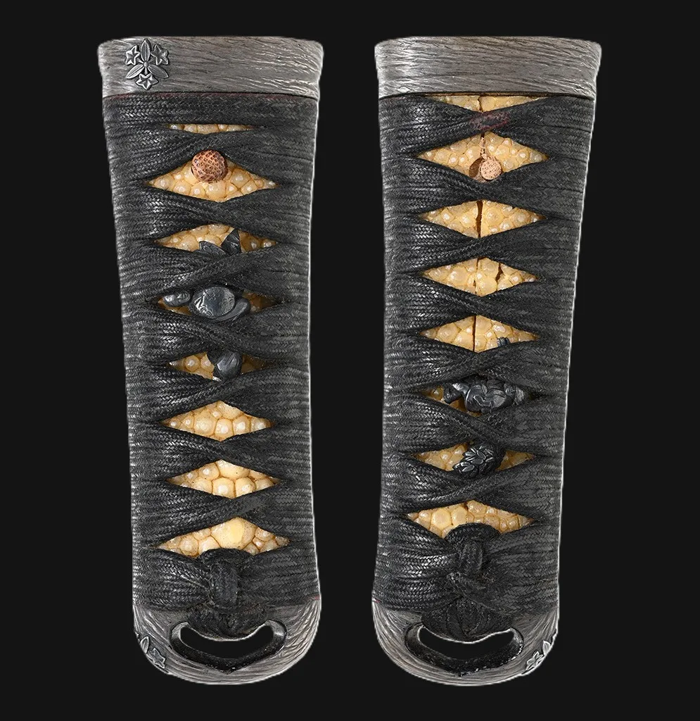 Side view of a black-wrapped Kawachi no Kami Hironobu Tantō katana with Imperial Kikumon, detailed hilt.