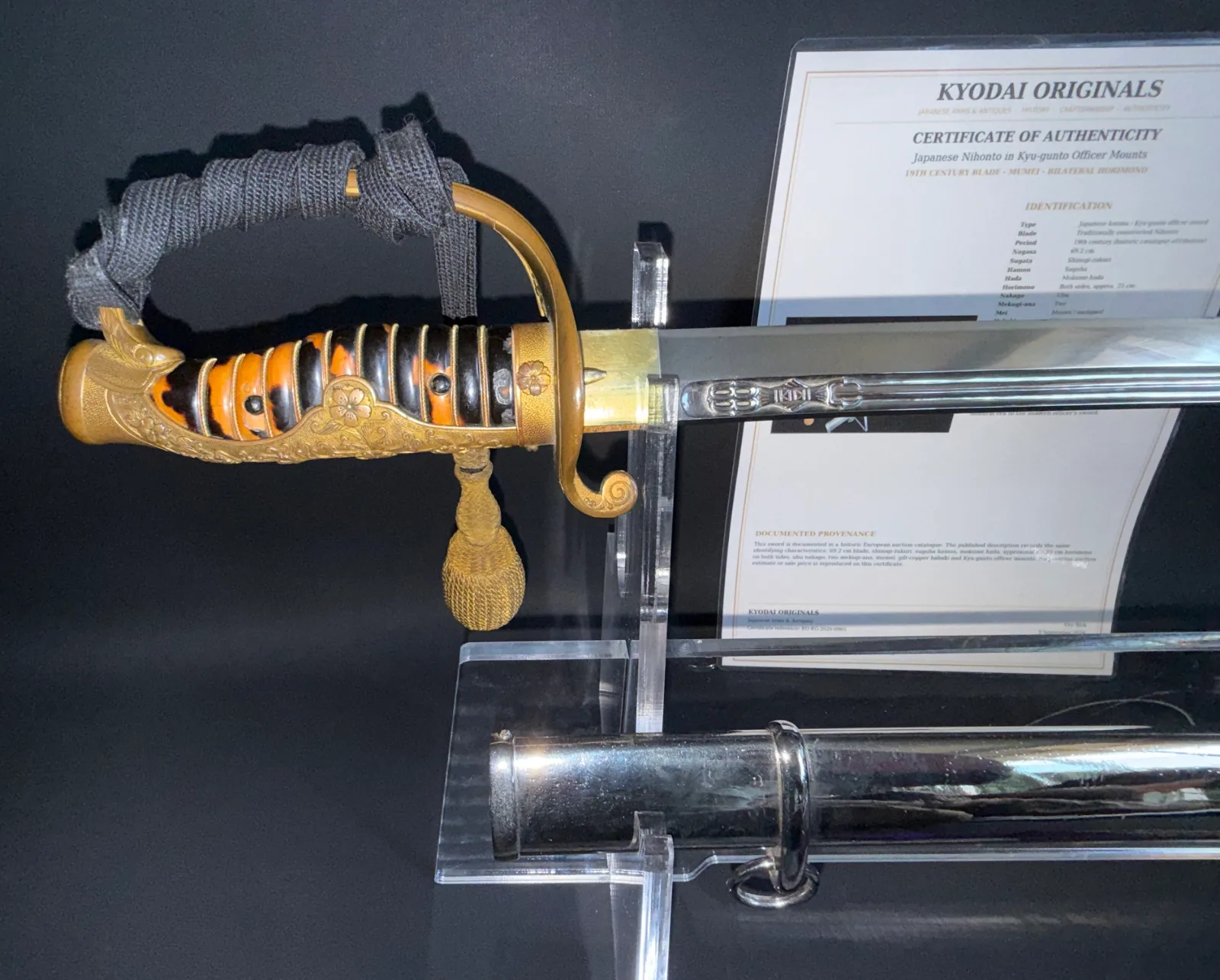 Japanese General Officer's Kyū-Guntō katana, close up of ornate handle, gilded guard, and engraved Nihontō blade