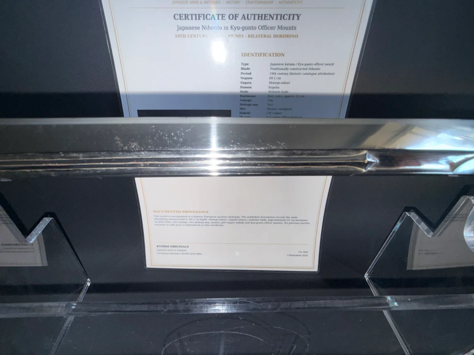 Japanese General Officer’s Kyū-Guntō katana with certificate of authenticity, close up of blade reflections.