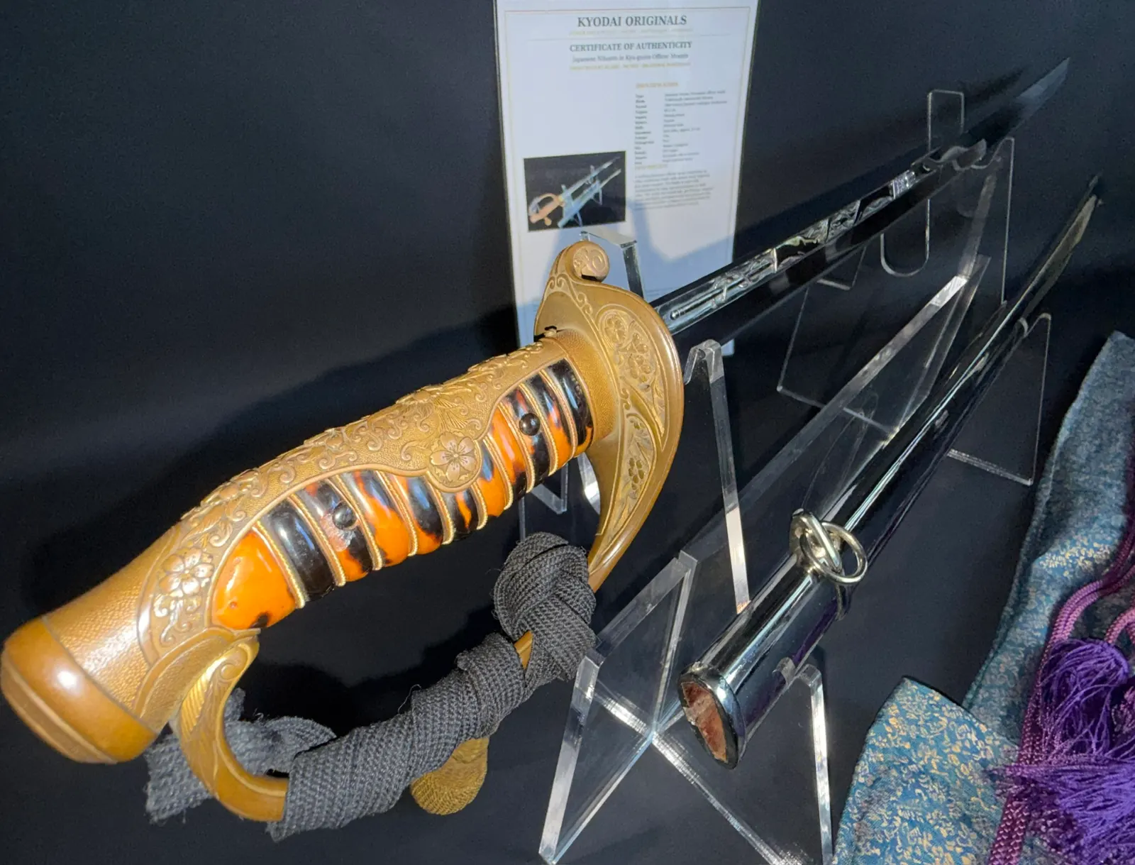 Kyū-Guntō katana, golden hilt, orange grip, and exposed Gassan School Nihontō blade with horimono engraving