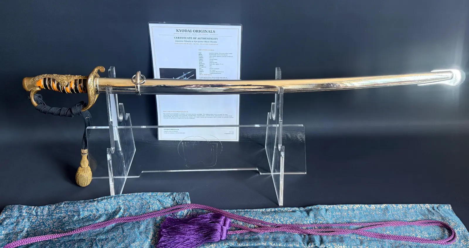 Japanese General Officer’s Kyū-Guntō katana on display, full length, showing ornate hilt and certificate