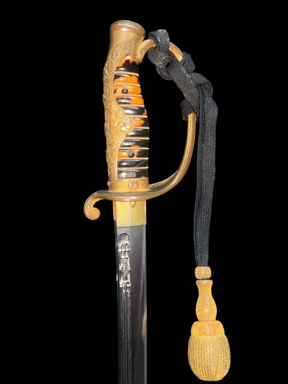 Kyū-Guntō katana with ornate gold hilt, tortoiseshell grip, and visible horimono on Gassan blade, close-up