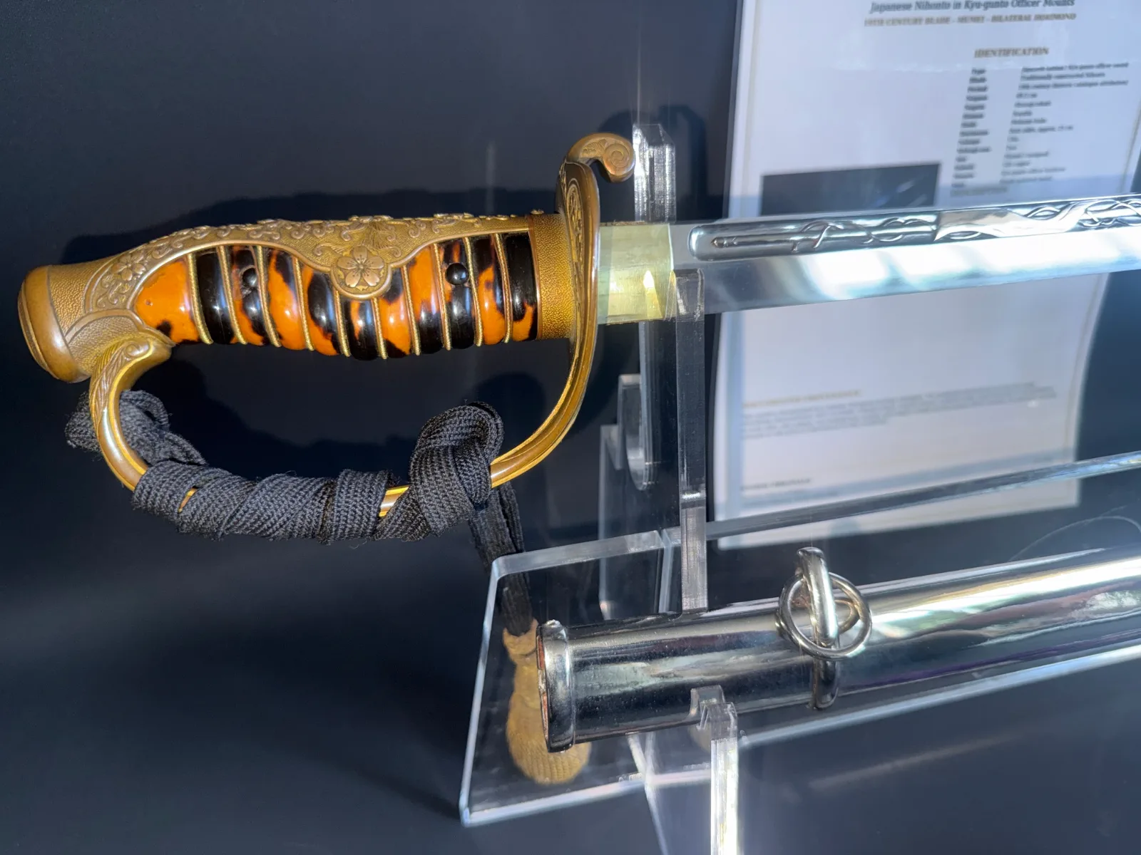 Japanese General Officer’s Kyū-Guntō katana, close-up of tiger-stripe grip and ornate blade horimono