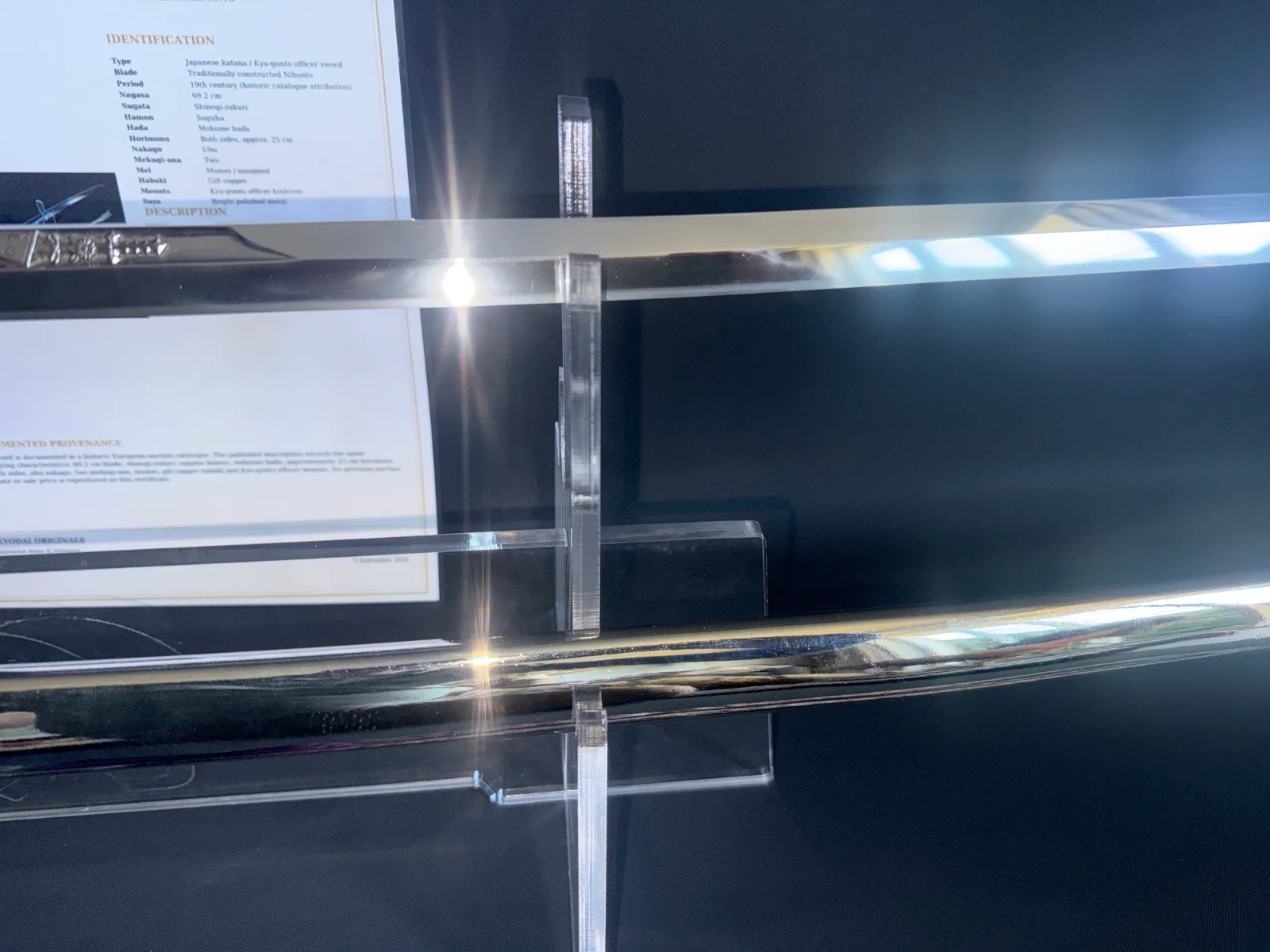 Japanese General Officer’s Kyū-Guntō katana blade on display, showing sharp edge and identification card detail