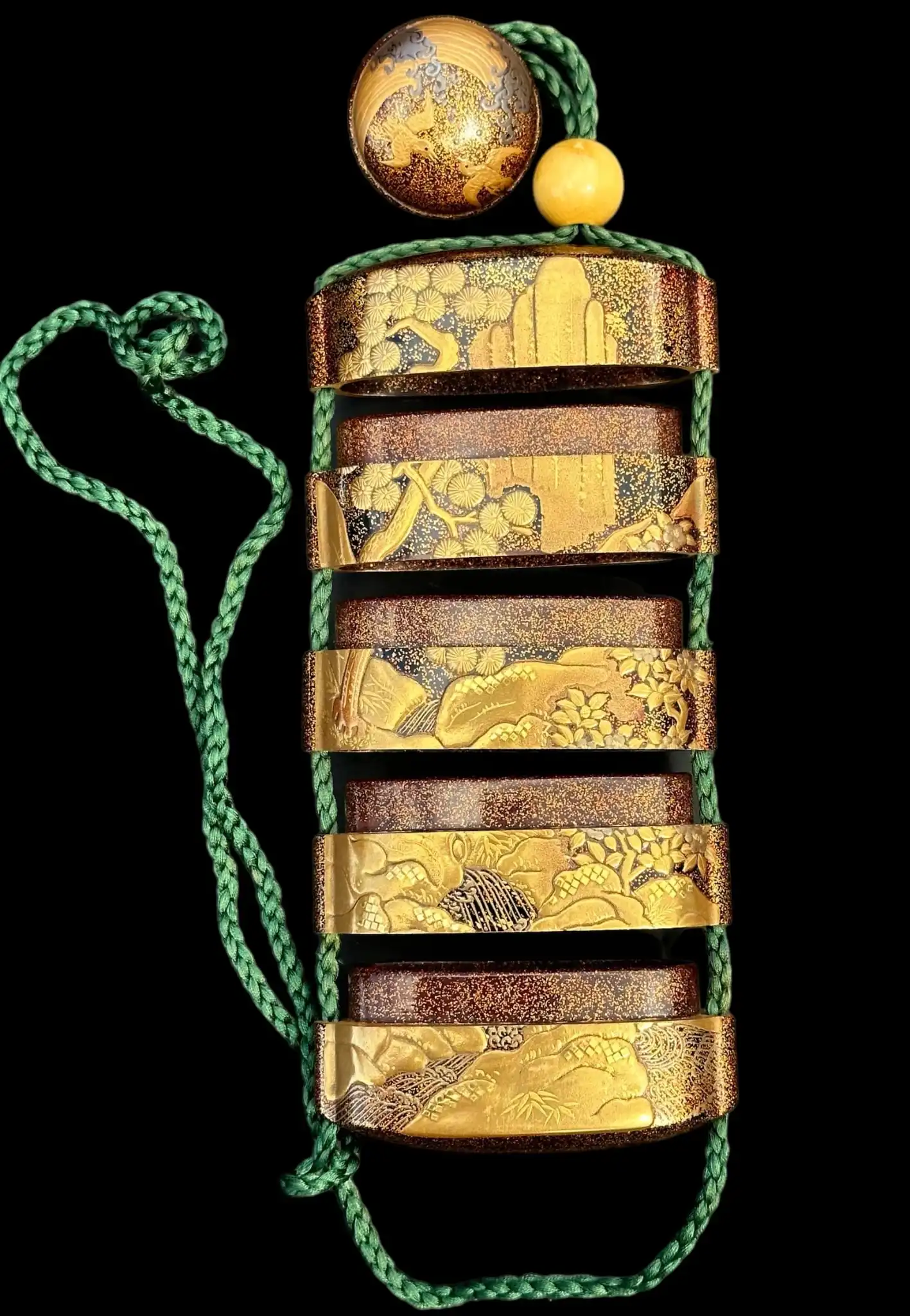 Antique Inro 1840 Makie accessory with intricate gold lacquer art and green cord, close-up view