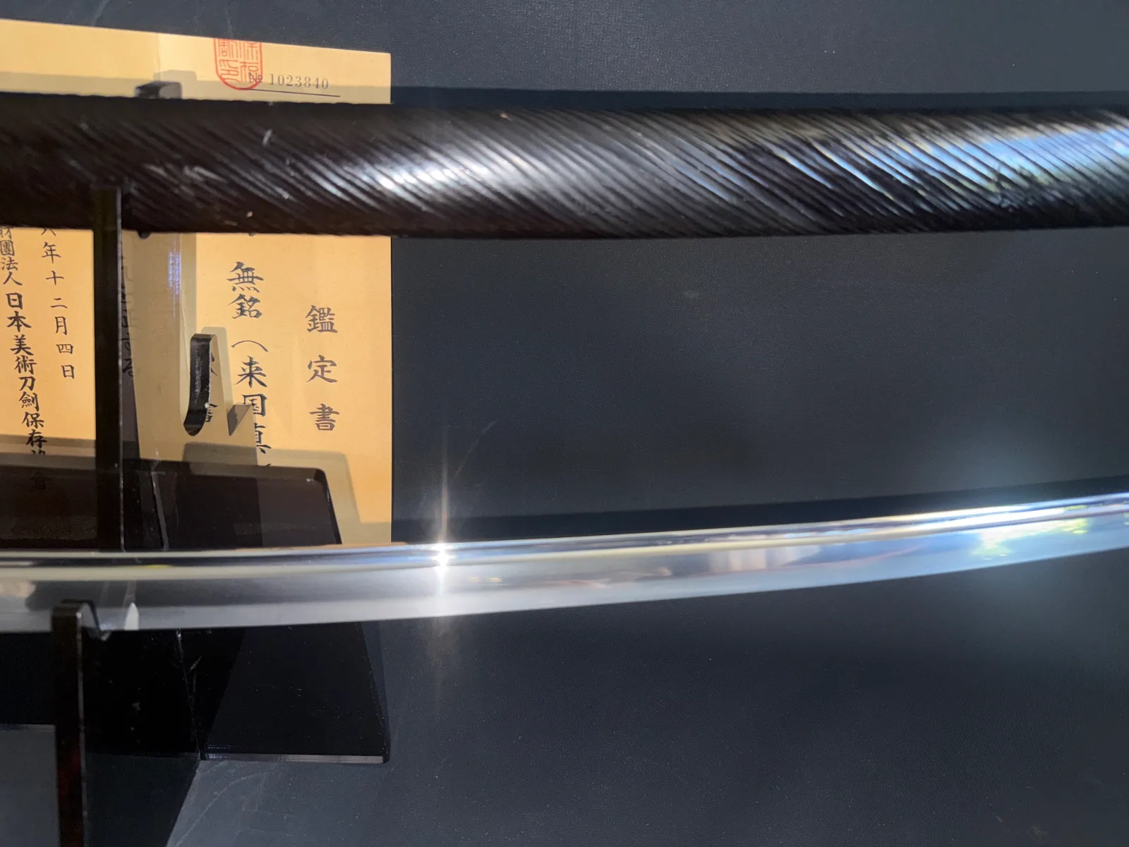 Close-up of a Kamakura Katana Rai Kunizane Tokubetsu Hozon katana blade on a stand with certification
