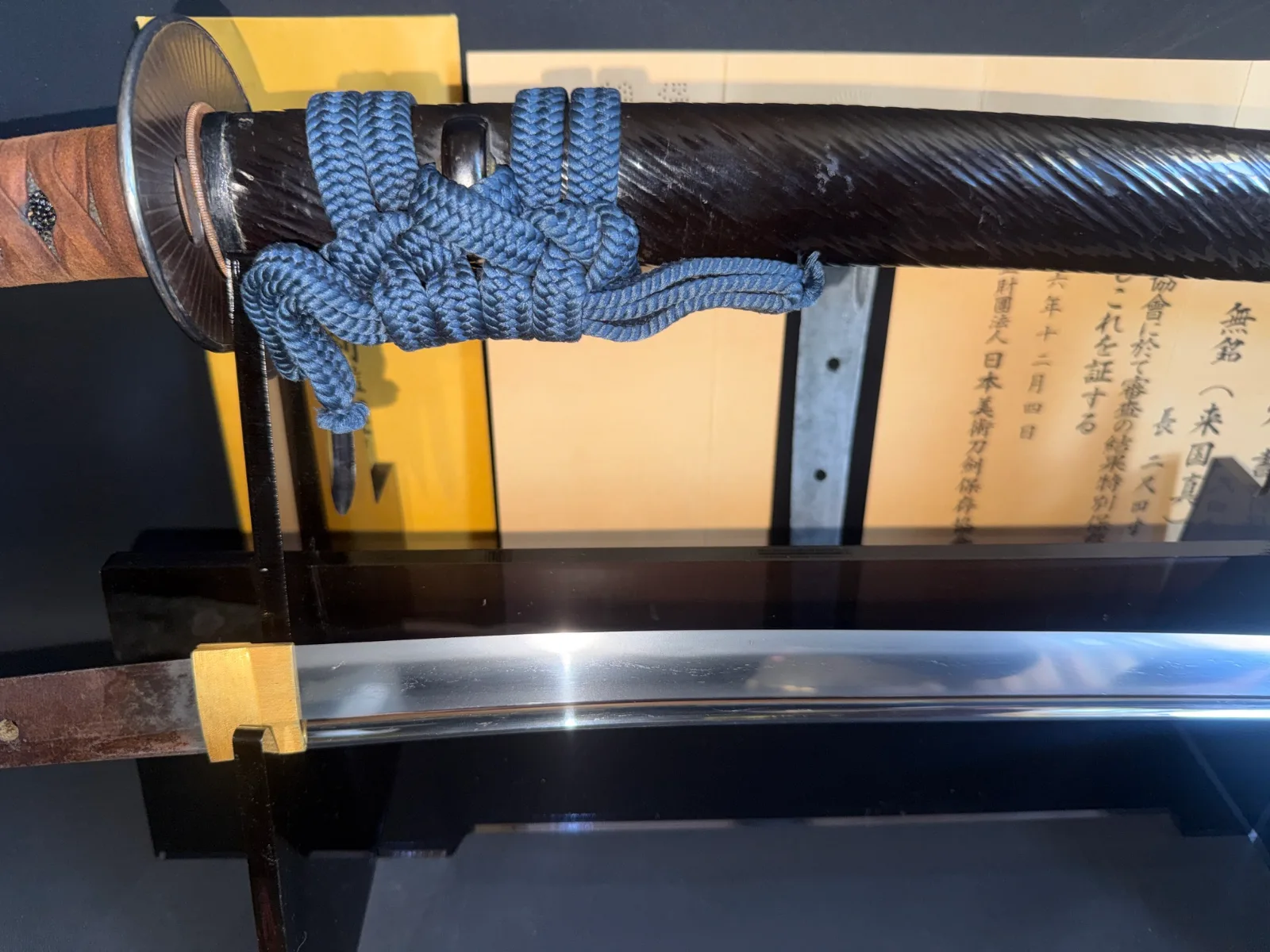 Kamakura Katana Sword Attributed to Rai Kunizane, a katana with dark scabbard, blue sageo, and visible blade