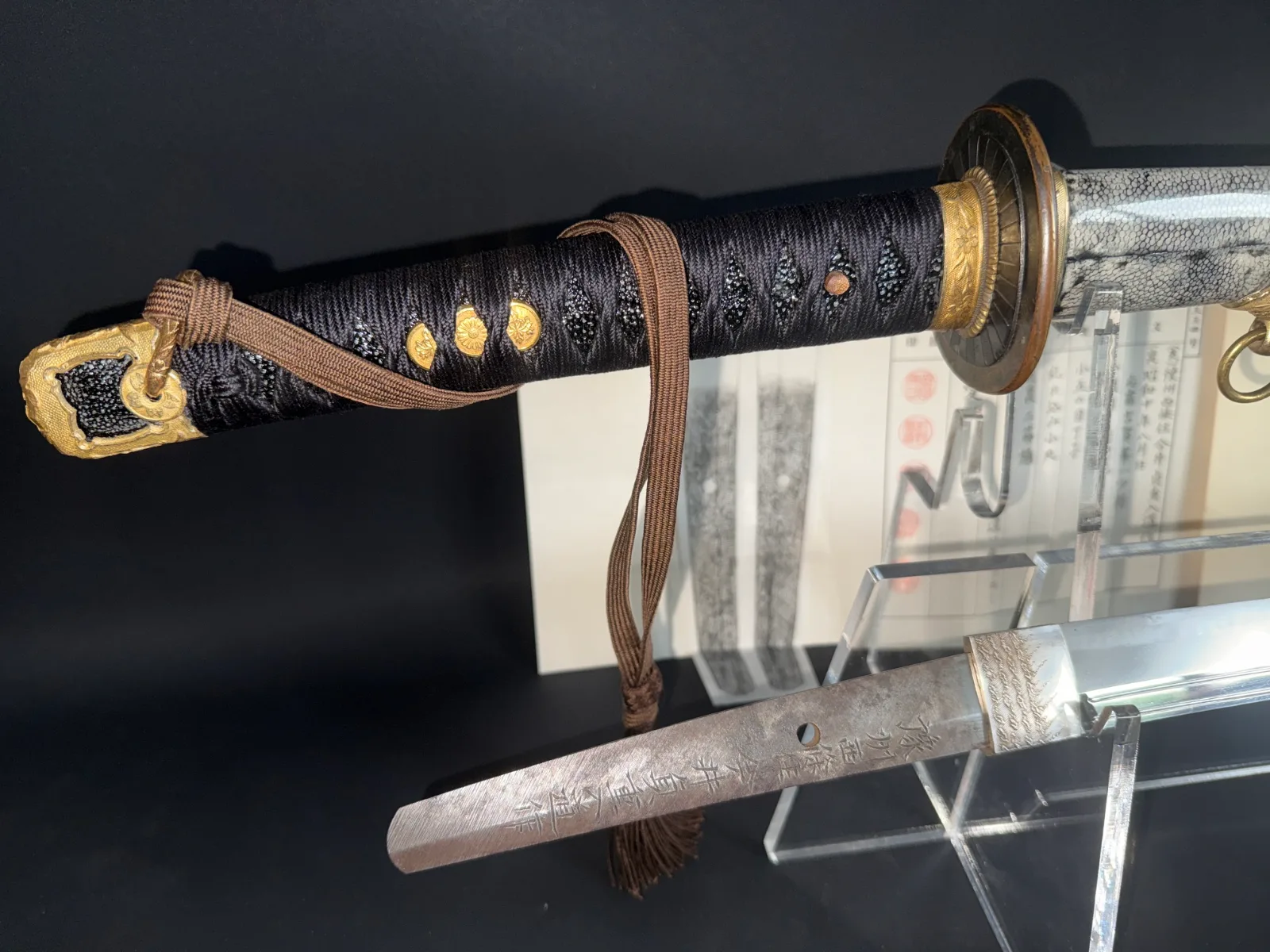 Close-up of a Naval Commissioned Gendaitō katana by Sadashige Gassan, showing the hilt and part of the tang.