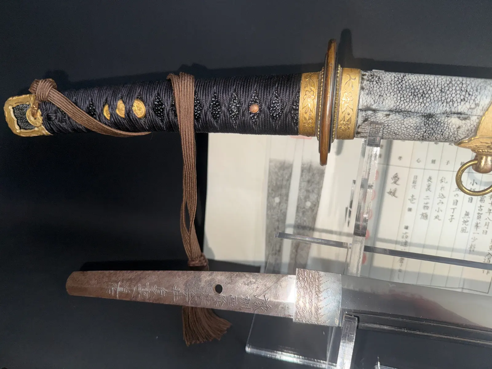 Close-up of a Naval Commissioned Gendaitō katana by Sadashige Gassan, its handle and tang with inscription visible