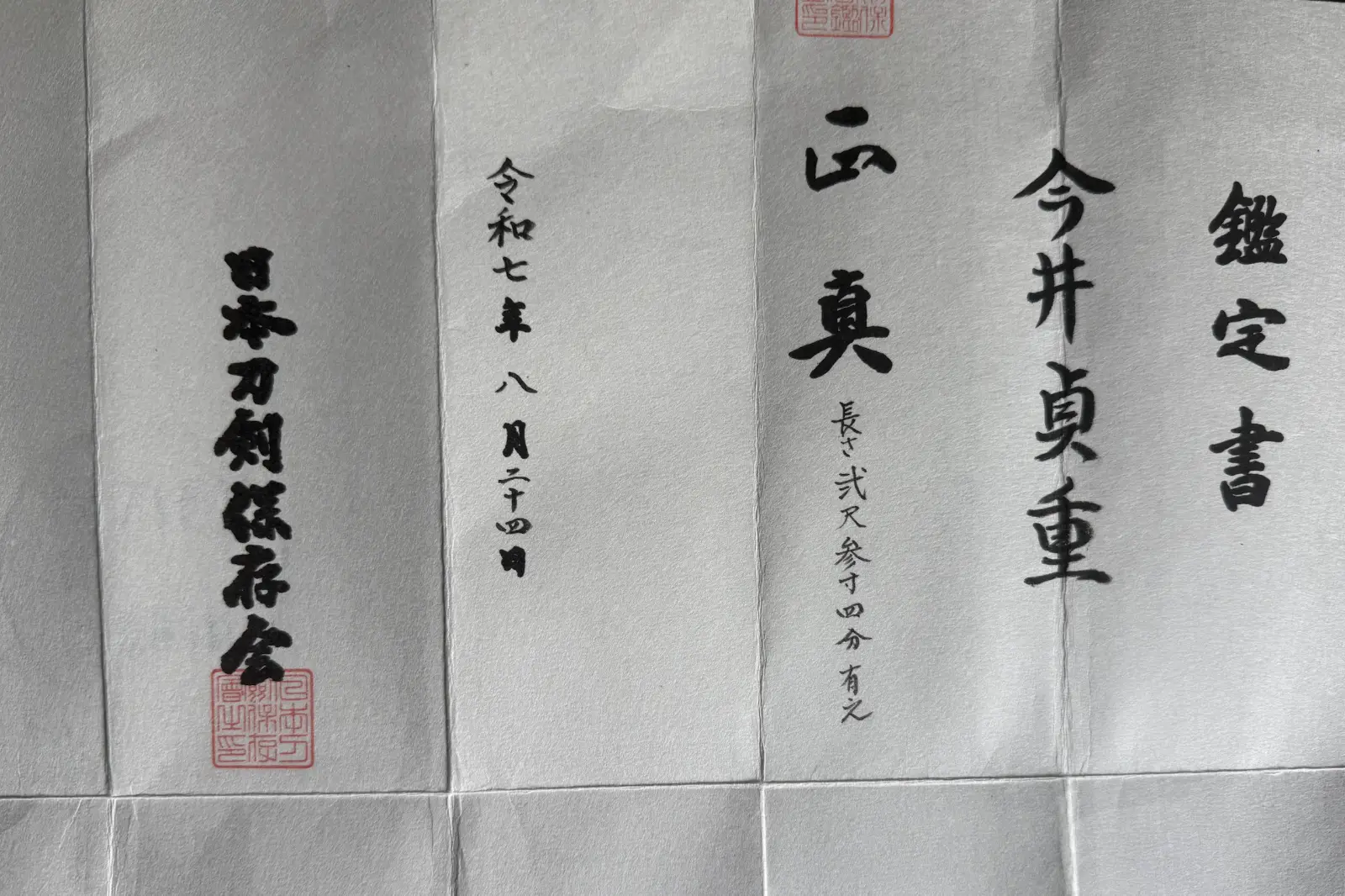 Close-up of the kanji writing on the documentation for the Naval Commissioned Gendaitō katana