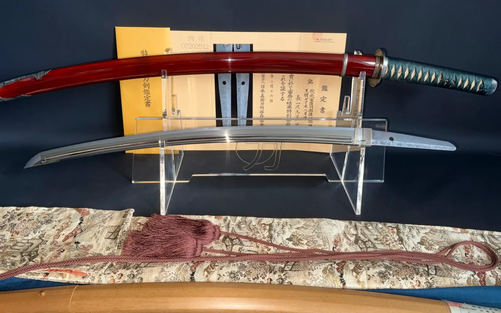 Suishinshi Masahide Wakizashi NBTHK Tokubetsu Hozon, a Japanese sword with red scabbard and papers displayed
