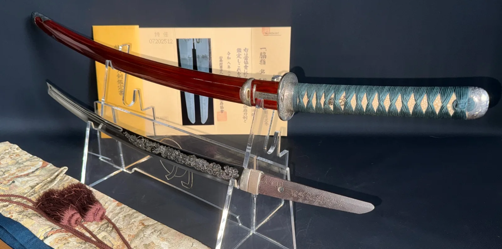 Suishinshi Masahide Wakizashi NBTHK Tokubetsu Hozon, displayed on a stand with its richly lacquered scabbard.