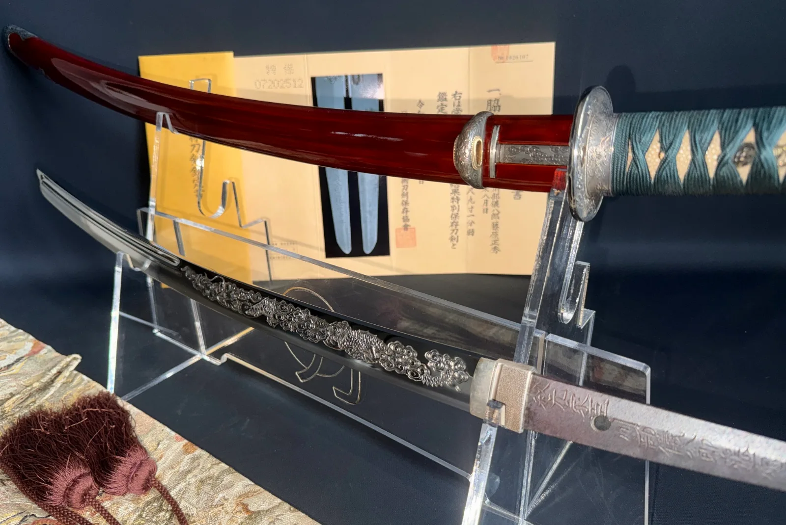Suishinshi Masahide Wakizashi NBTHK Tokubetsu Hozon, katana and saya on display with ornate silver fittings