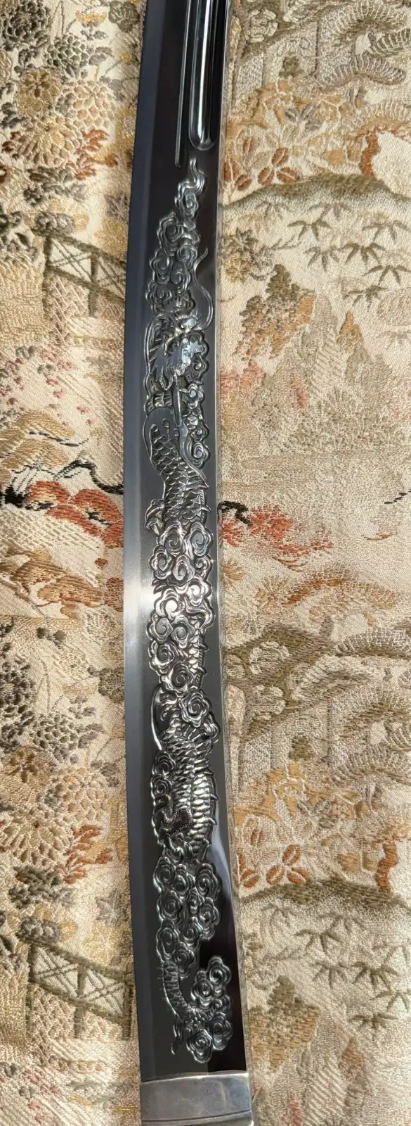 Close-up of the carved dragon horimono on a Suishinshi Masahide Wakizashi NBTHK Tokubetsu Hozon blade.
