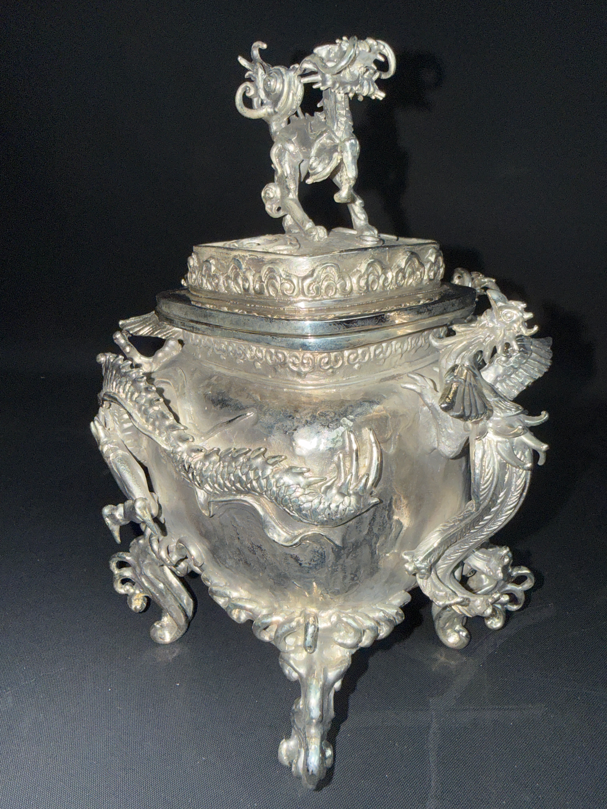 Intricate silver Takaoka Bronze Kōro ACCESSORIES with ornate dragon details and a mythical beast on the lid, frontal view