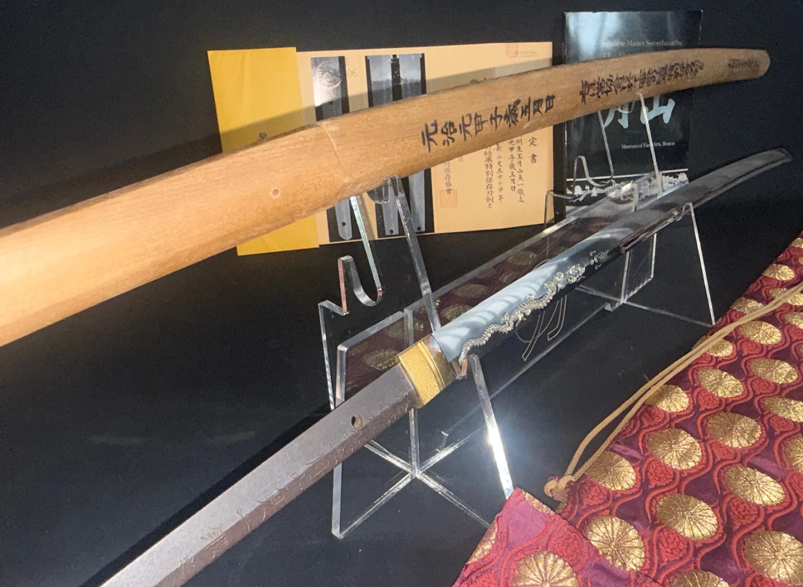 Japanese Masterpiece Katana by Gassan Sadakazu blade on a stand, with inscribed shirasaya & brocade bag.