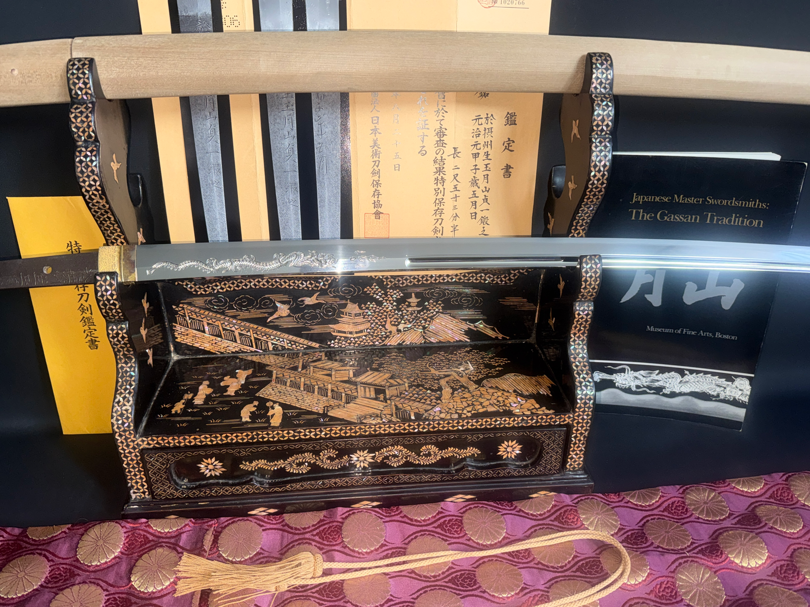 Japanese Masterpice Katana by Gassan Sadakazu, NBTHK Tokubetsu Hozon, displayed on an ornate stand with documentation