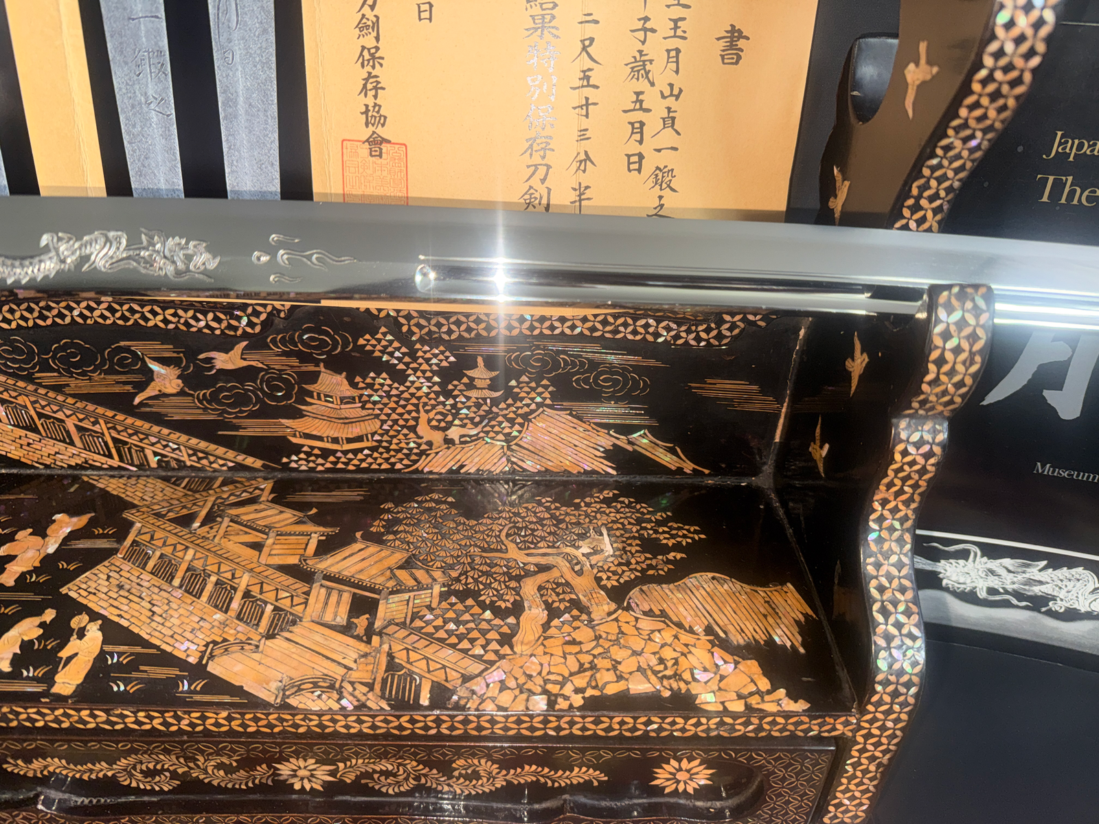 Japanese Masterpiece Katana by Gassan Sadakazu blade reflected on ornate raden lacquer stand with documents