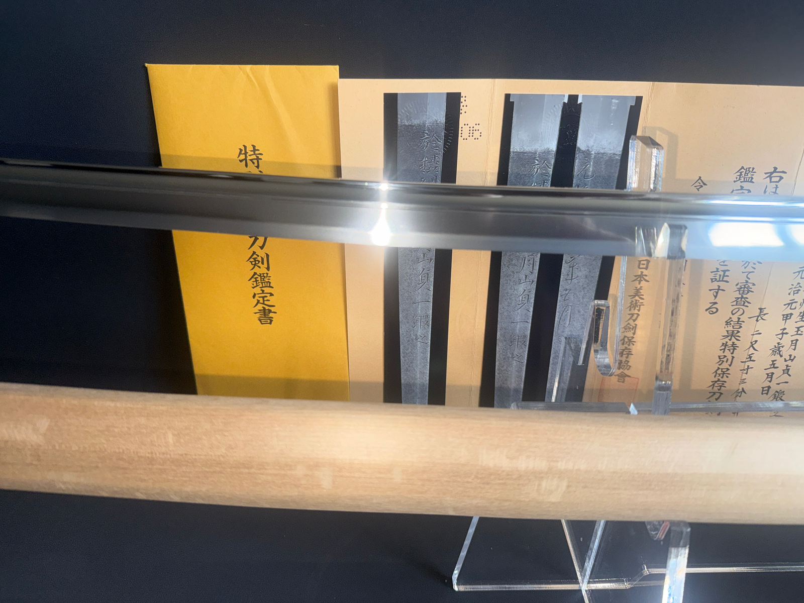 Japanese Masterpiece Katana by Gassan Sadakazu, its shiny blade over Tokubetsu Hozon NBTHK documentation