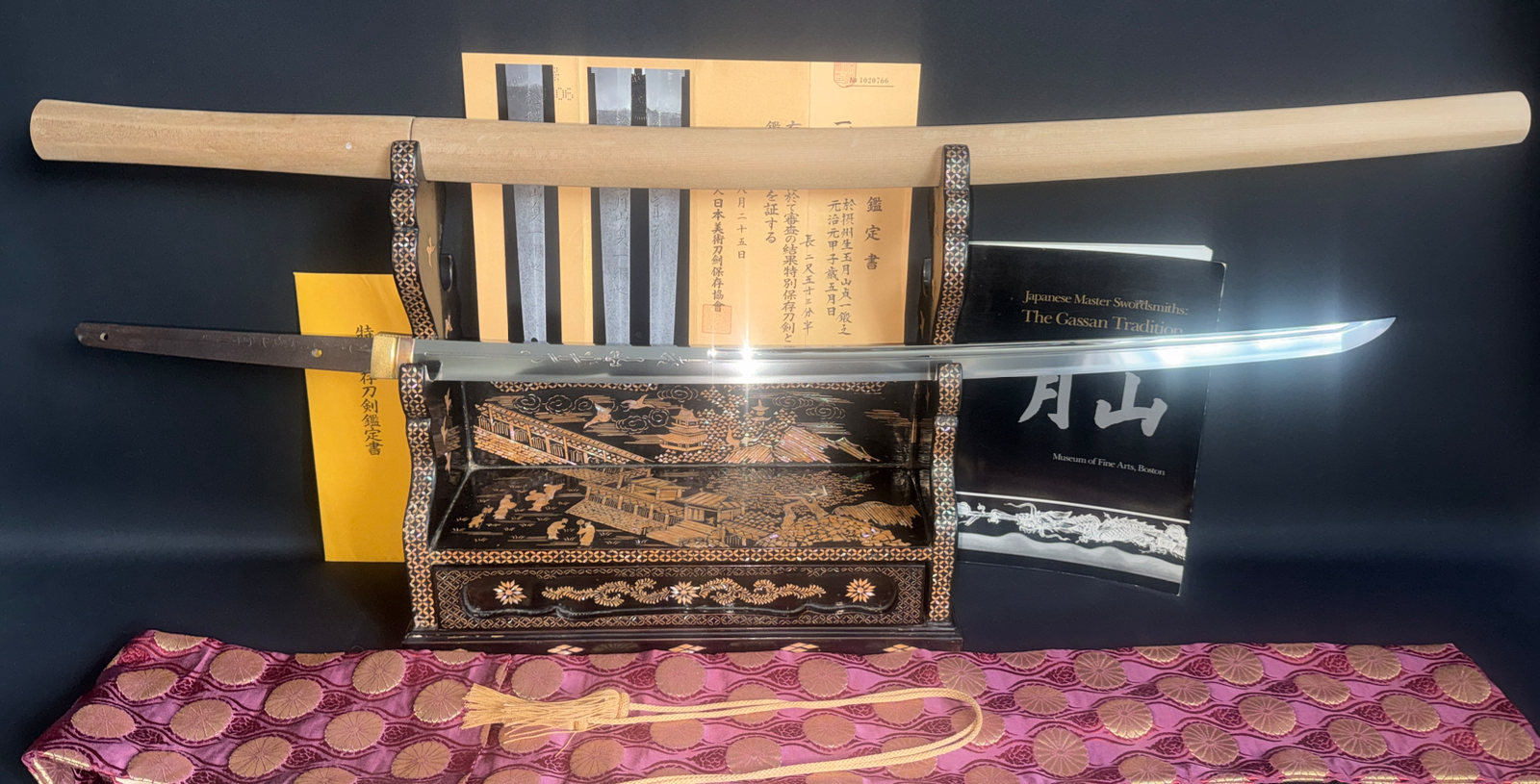 Japanese Masterpiece Katana by Gassan Sadakazu, NBTHK Tokubetsu Hozon, displayed on an ornate stand with documentation