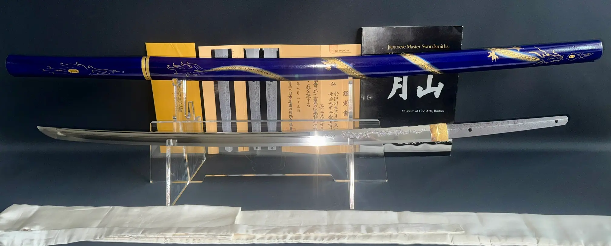 Japanese Masterpiece Gassan Sadakazu NBTHK Tokubetsu Hozon katana, blade displayed above ornate blue saya.