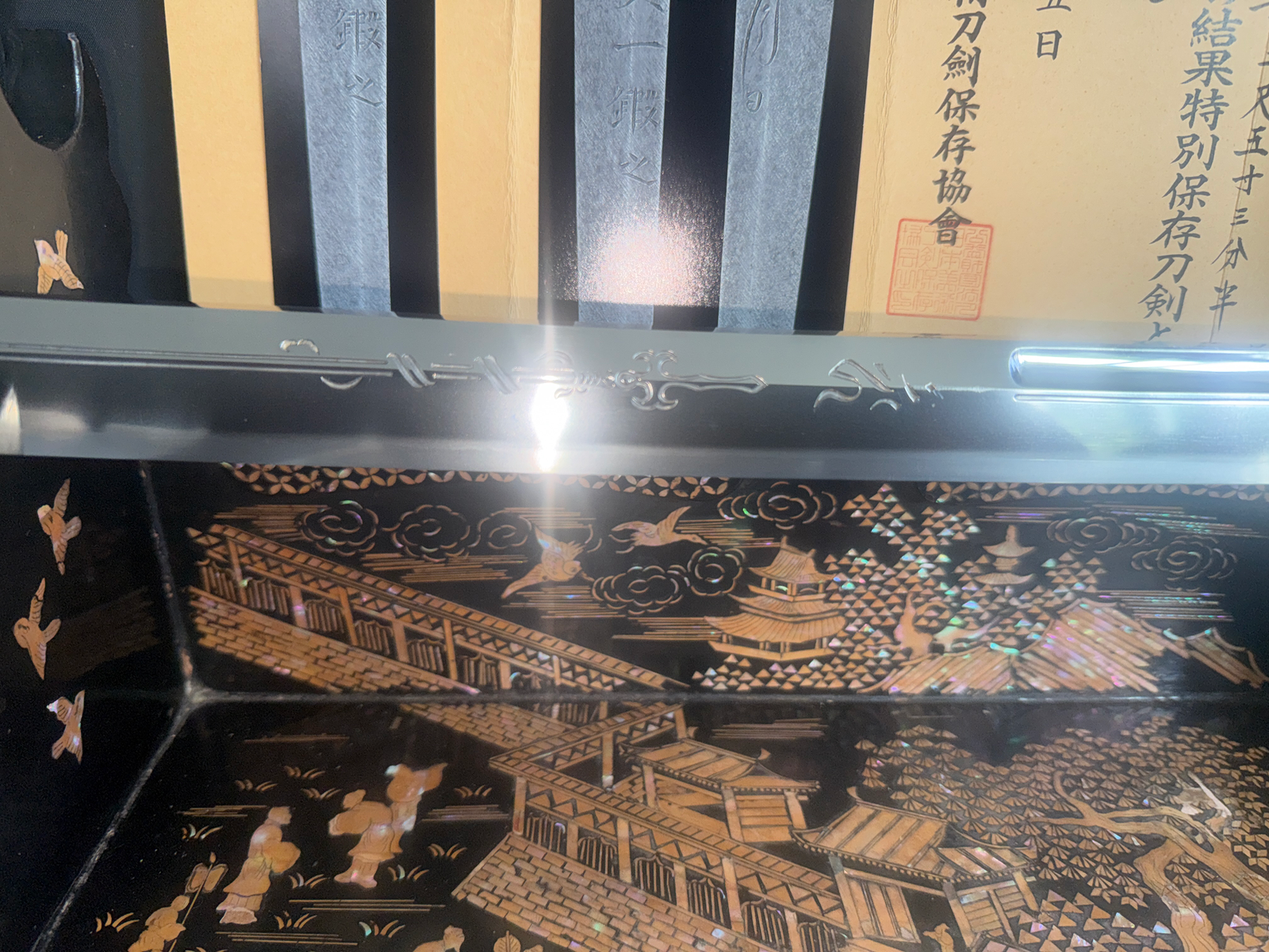 Gassan Sadakazu katana blade with detailed horimono and NBTHK papers above ornate lacquered saya with shell inlay