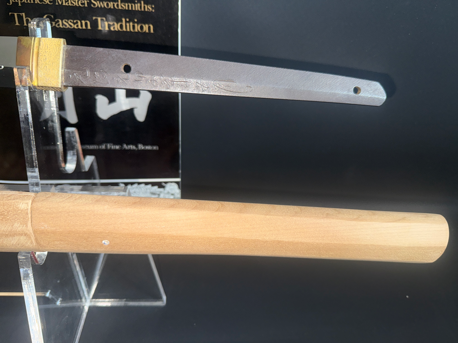 Gassan Sadakazu katana tang with mei and habaki visible, next to wooden shirasaya. Japanese masterpiece sword.