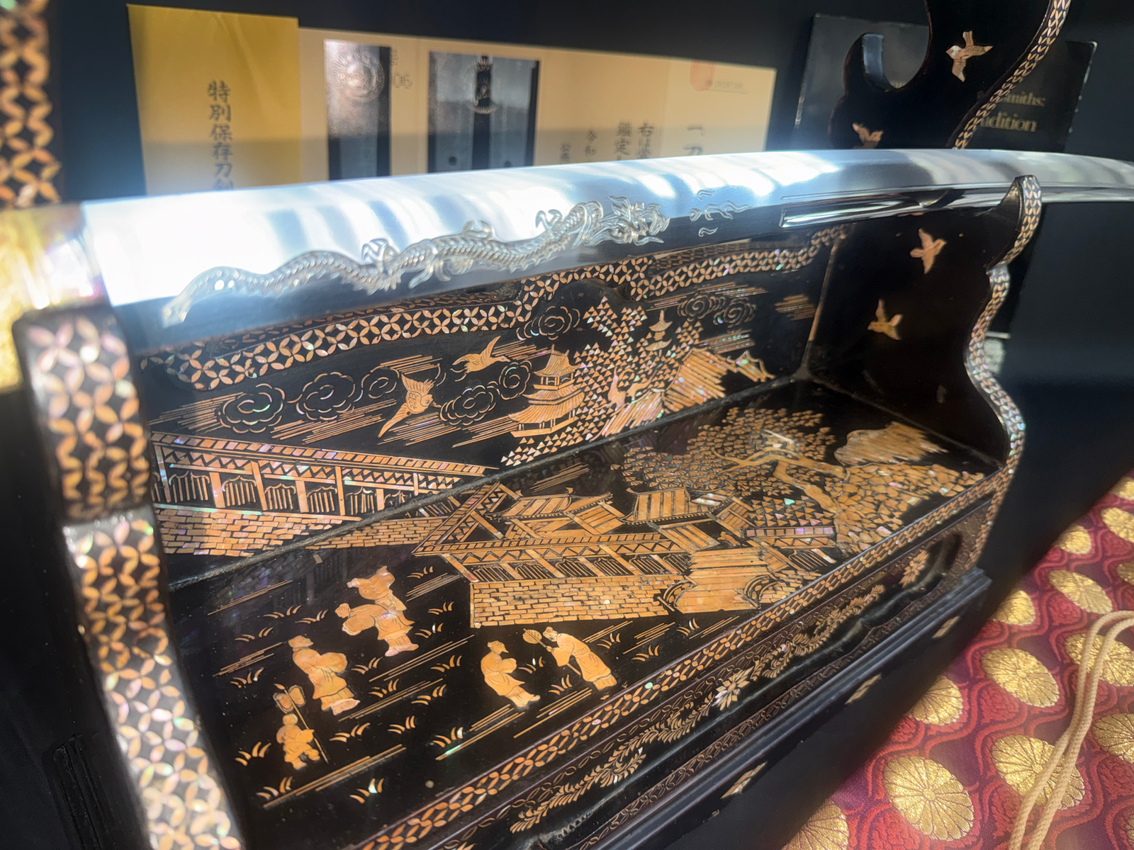 Japanese Masterpiece Katana by Gassan Sadakazu on a highly detailed black lacquer stand with mother-of-pearl inlay scene.