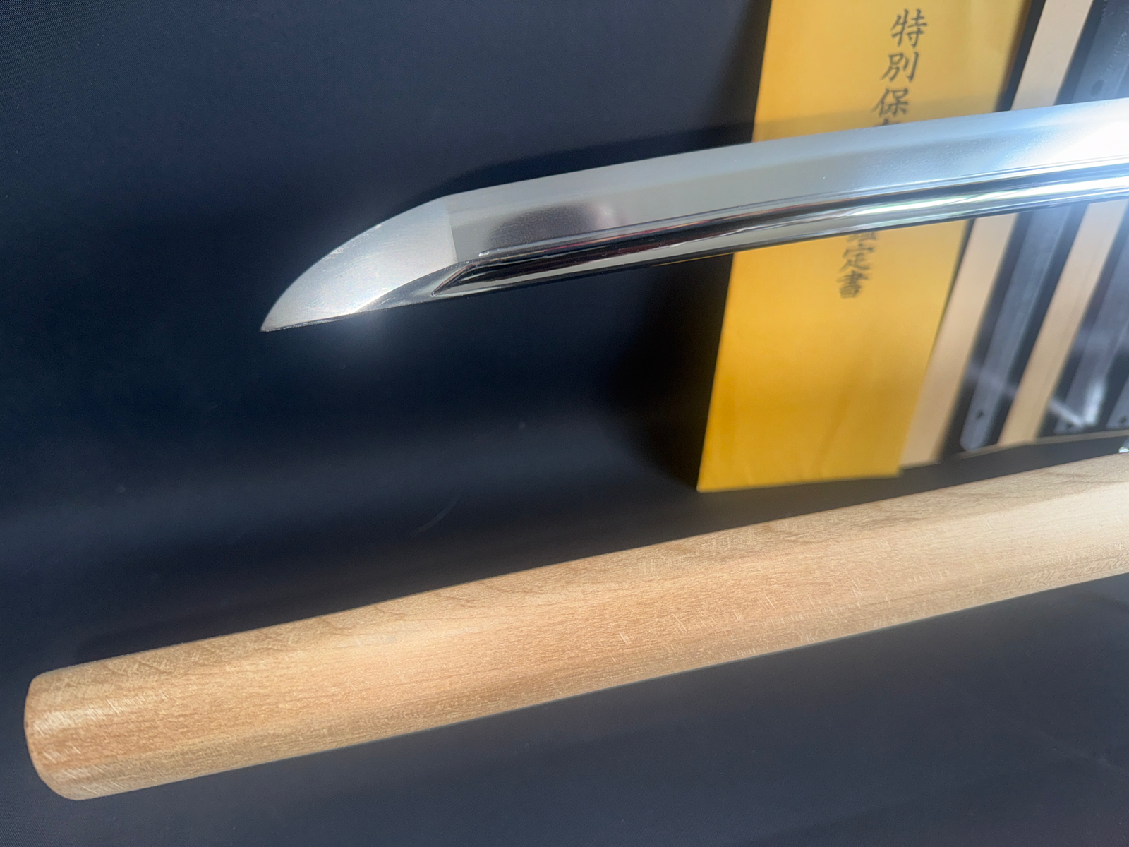 Japanese Masterpiece Katana by Gassan Sadakazu NBTHK Tokubetsu Hozon, blade tip with scabbard & document in background