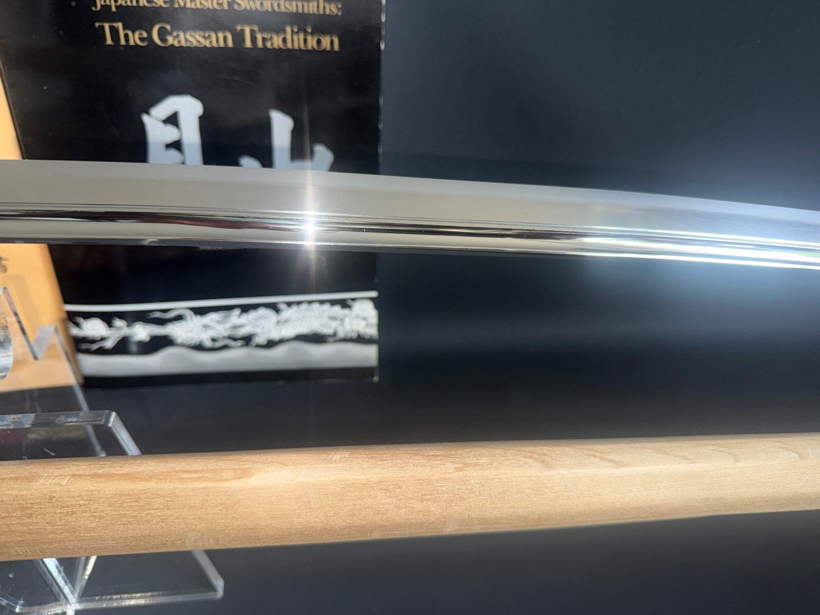 Gassan Sadakazu Masterpiece Katana blade close-up, sharp reflections on polished steel, with original shirasaya wood
