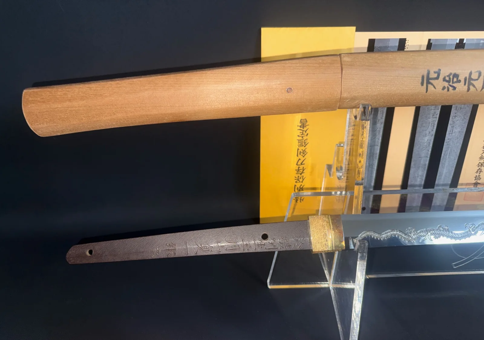 Gassan Sadakazu masterpiece katana displayed with tang inscriptions, wooden shirasaya and documentation in a close-up angle