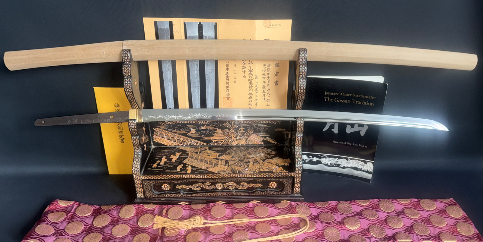 Japanese Masterpice Katana by Gassan Sadakazu NBTHK Tokubetsu Hozon on display stand with documentation.