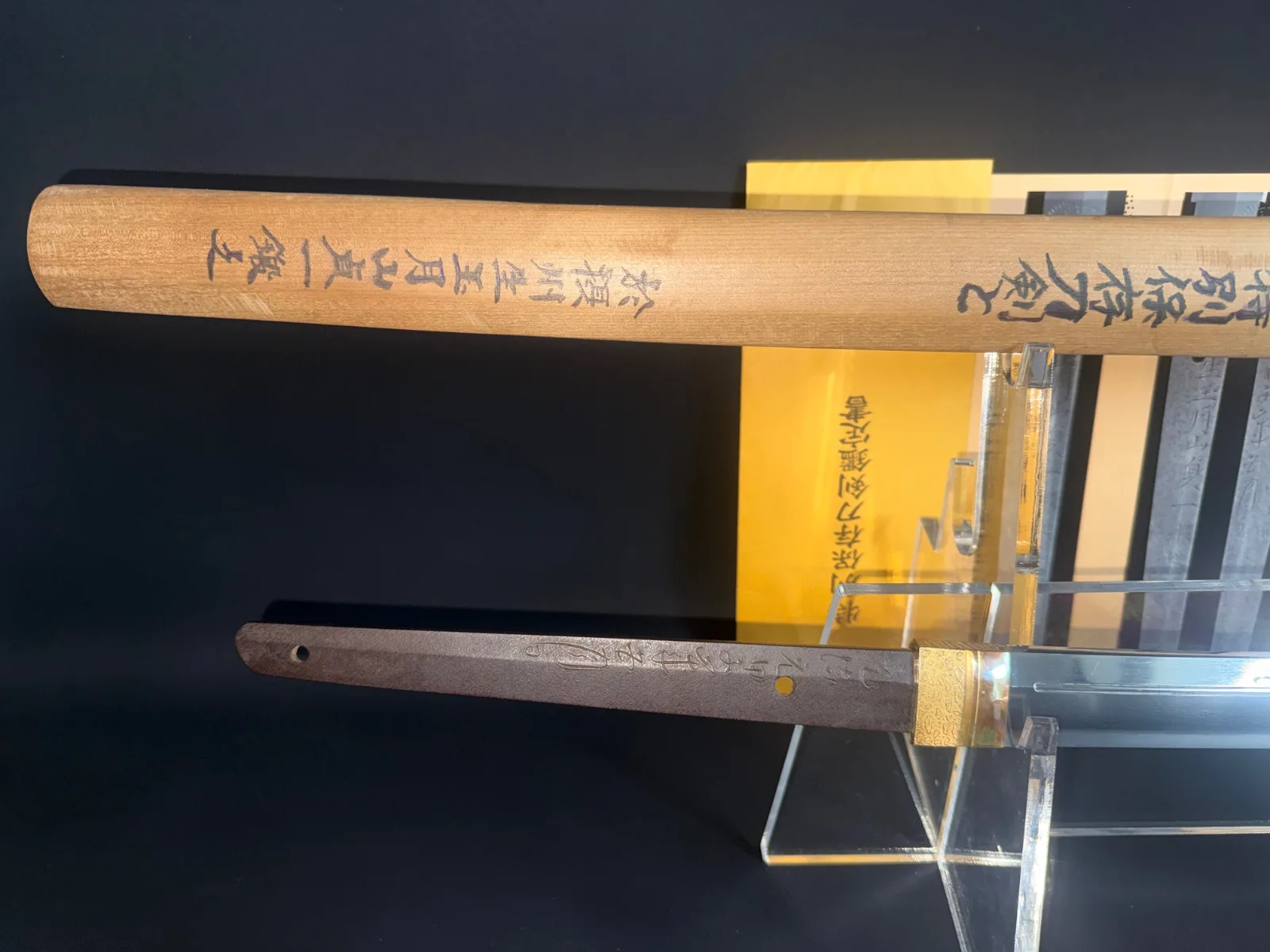 Gassan Sadakazu katana tang and saya with inscription, a Japanese Masterpiece Katana, on display with NBTHK documents