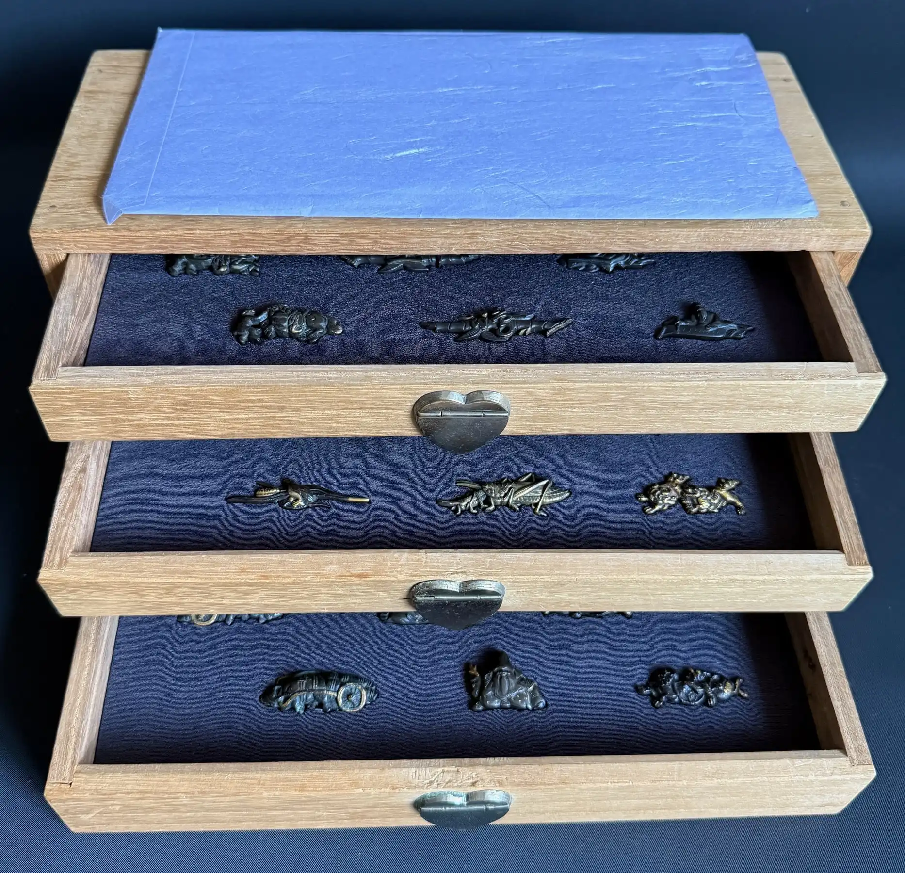Menuki 9 pairs Edo Period Samurai Sword Accessories in Kiri box, full view from above