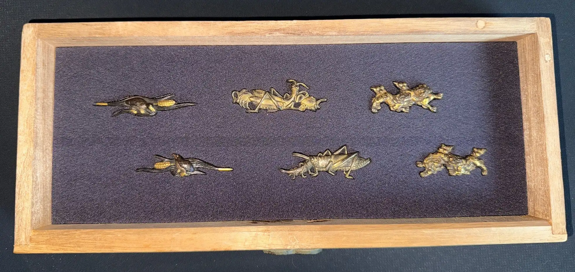 Top-down view of six pairs of Edo period Japanese samurai sword Menuki Accessories in a kiri box