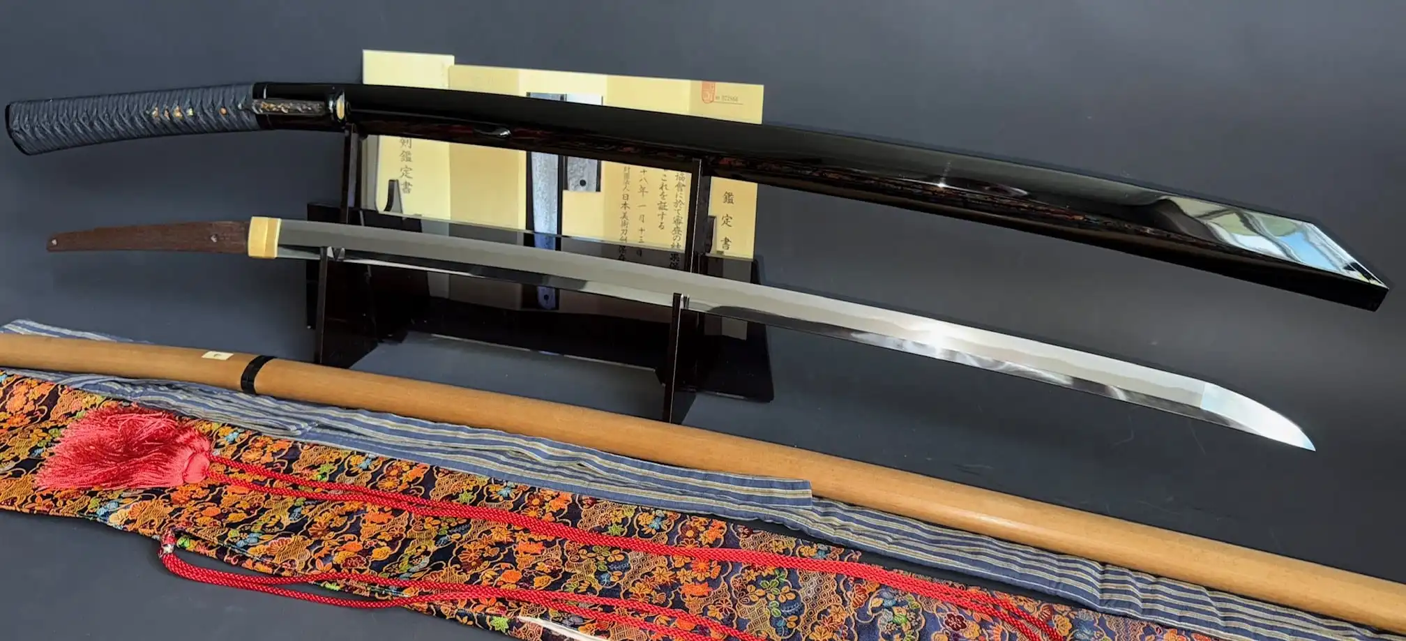 Jinja Hōnō Tachi Naganobu katana, bare blade and lacquered scabbard with certificates and antique fabrics