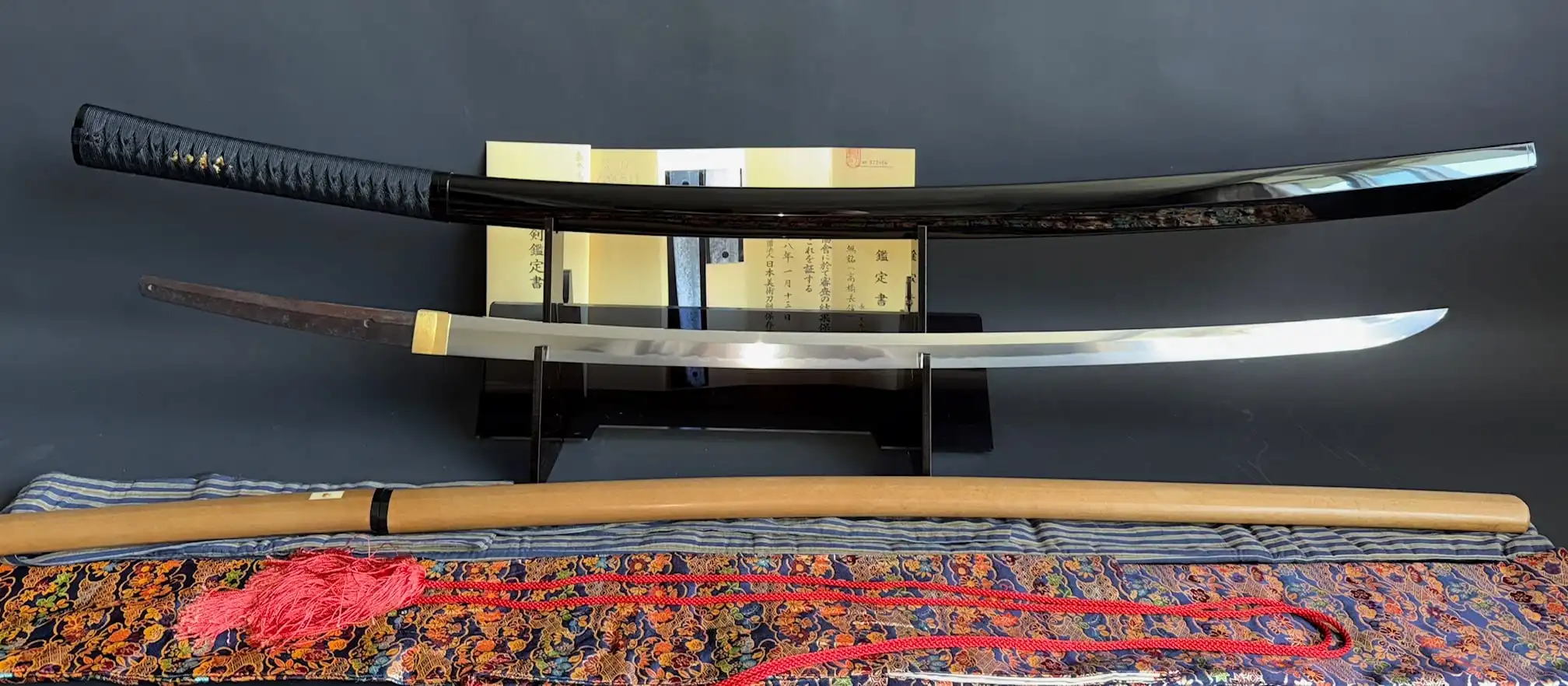 Full view of Jinja Hōnō Tachi Naganobu Katana with scabbard, blade, and accessories on display