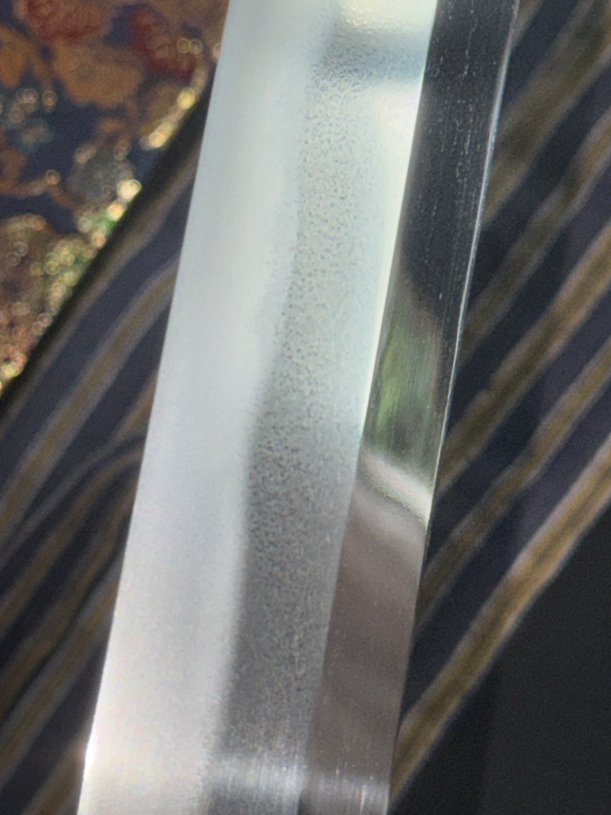 Close-up of the polished blade with visible hamon and jihada of Jinja Hōnō Tachi Naganobu Katana