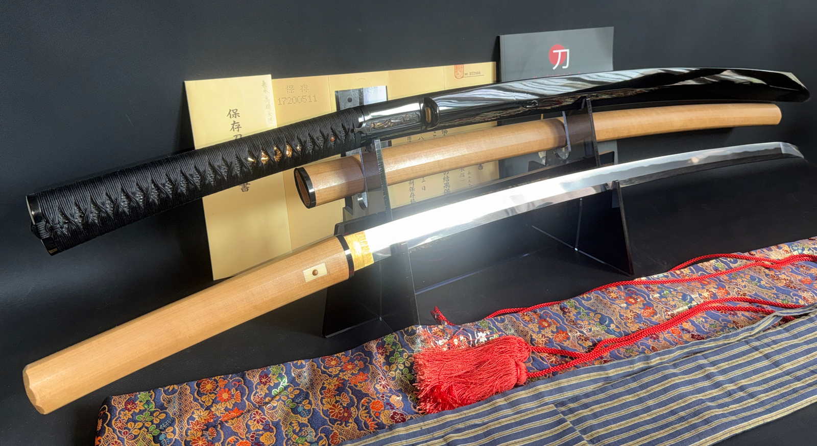 Jinja Hōnō Tachi Naganobu katana, a ceremonial Japanese sword, shown with saya and shirasaya on display.
