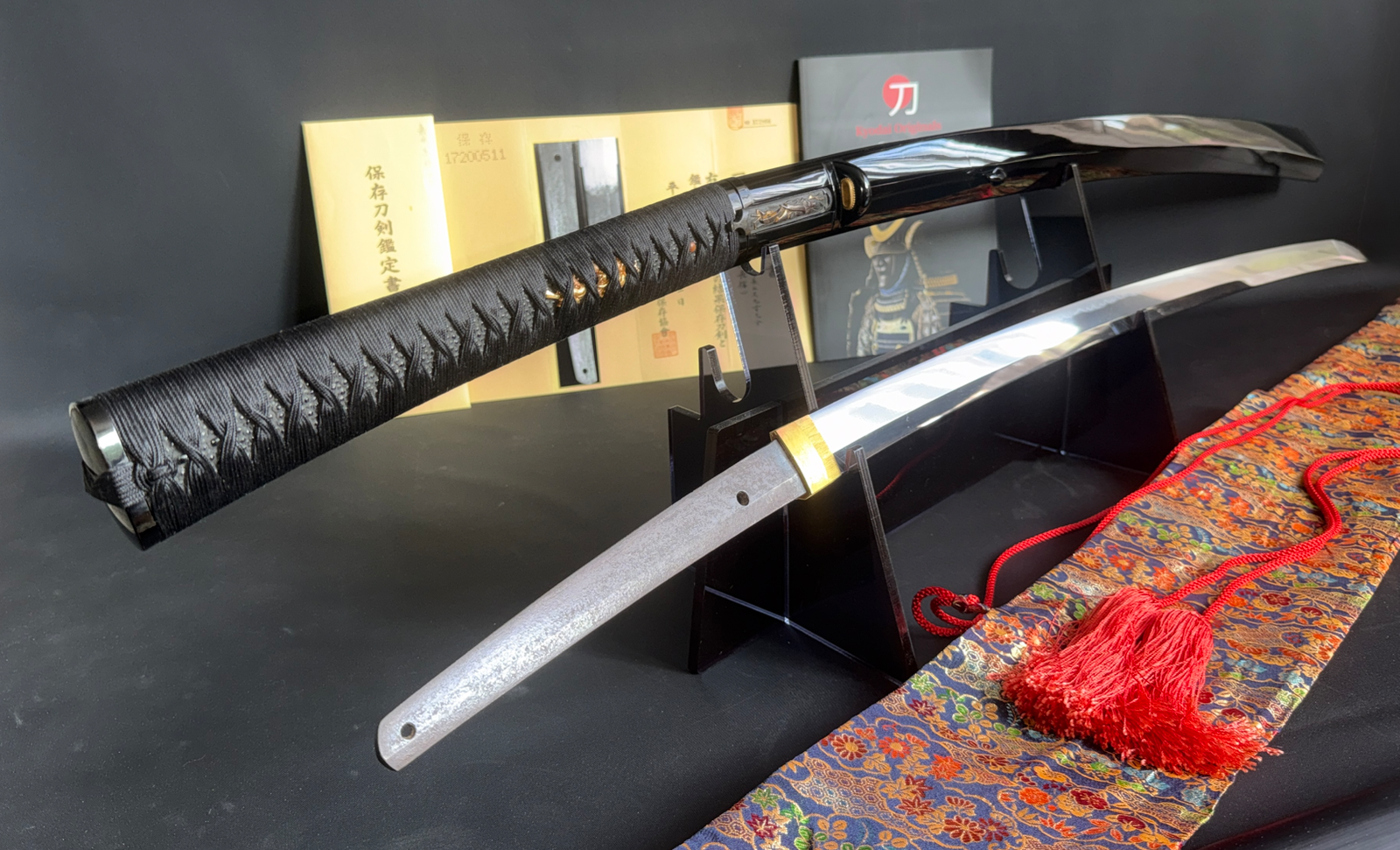 Jinja Hōnō Tachi Naganobu katana with black Tsuka-maki and polished blade, showcased on a stand.