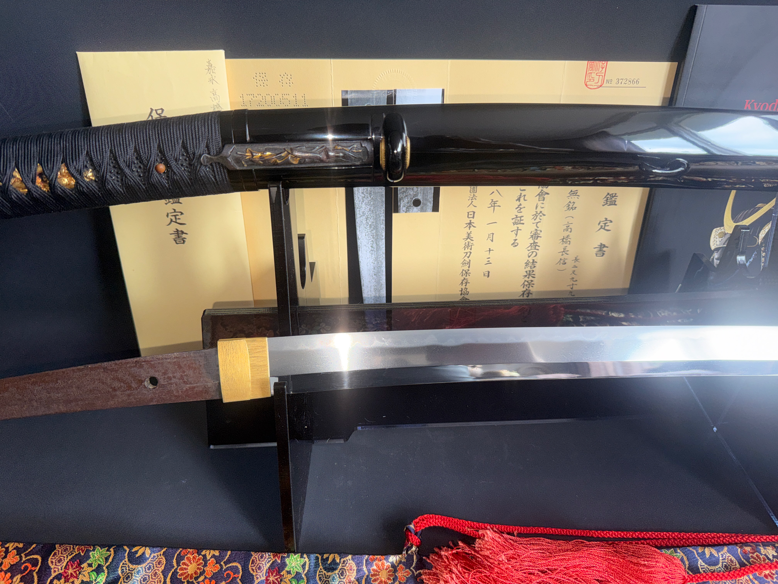 Jinja Hōnō Tachi Naganobu Katana blade and scabbard displayed with accompanying certification documents.